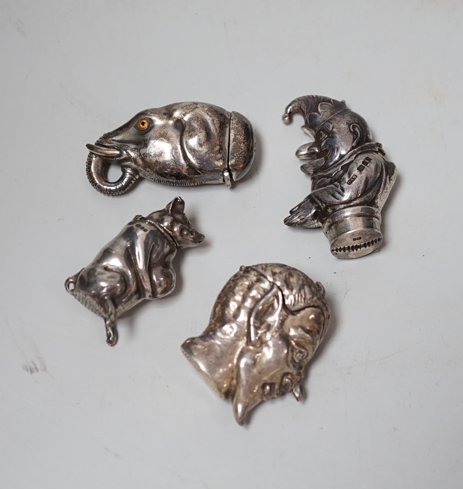 Four assorted modern silver figural vesta case including elephant, bear and Mr. Punch, largest 57mm.